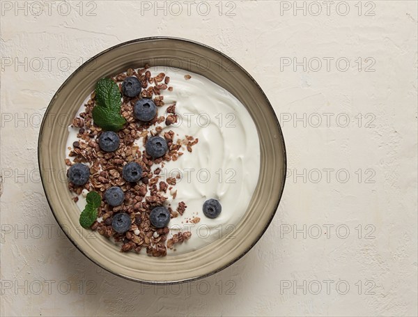 Yogurt with chocolate muesli, with berries, blueberries, breakfast, close-up, fork on top, no people