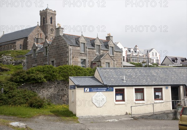 Tourist Information office, houses, hotel and church in Castlebay, Barra, Outer Hebrides, Scotland, UK