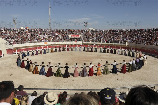 Women dancing in traditional costumes in the arena of Les Saintes Maries de la Mer, Parc Naturel Regional de Camargue, Bouches du Rhone, Provence, France, Europe