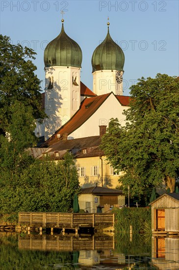 Romanesque Benedictine Abbey Seeon Monastery, monastery church St. Lambert with reflection in the monastery lake, calm smooth water in the evening light at sunset, Seeon-Seebruck, Chiemgau, Upper Bavaria, Bavaria, Germany, Europe