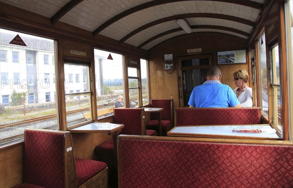 Passengers inside train carriage of Ffestiniog railway, Gwynedd, north west Wales, UK