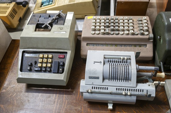 Vintage mechanical calculator adding machines on display at auction, UK including Brunsviga, Olivetti models