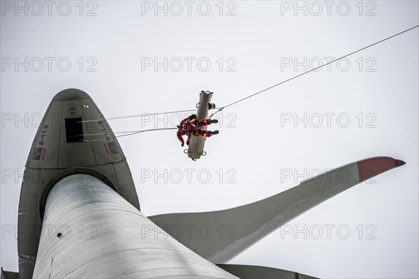 Height rescuers from the Oberhausen professional fire brigade practise abseiling from a wind turbine from a height of 150 metres, rescuing an injured person, technician, from the nacelle, Issum, North Rhine-Westphalia, Germany, Europe