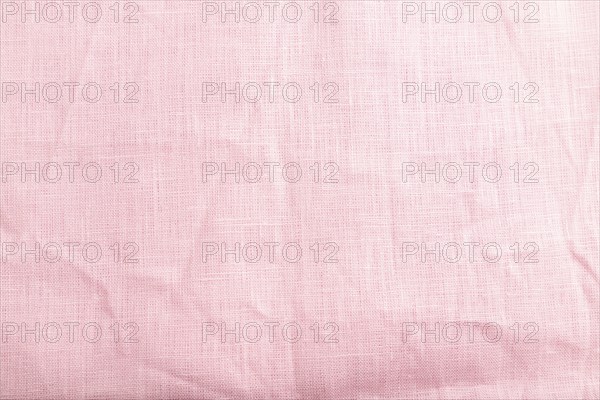 Fragment of smooth pink linen tissue. Top view, flat lay, natural textile background and texture