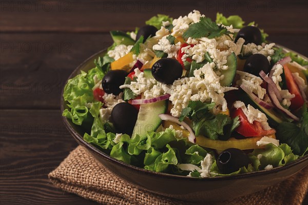 Traditional Bulgarian dish, Shopska salad, on a wooden table, salad of fresh vegetables, top view, close-up, no people, Bulgarian food, Bulgarian cuisine, salad, vegetables