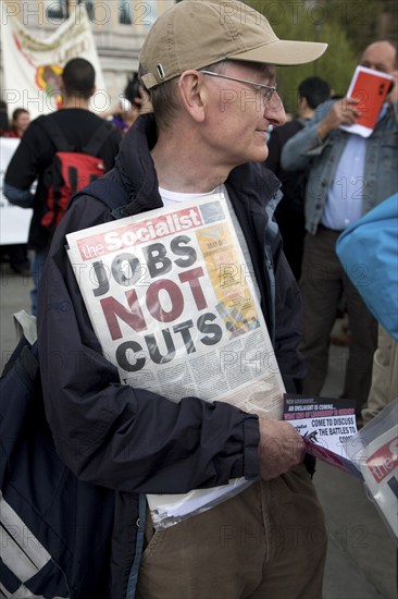 May Day march and rally at Trafalgar Square, London, England, UK May 1st, 2010 Man holding Socialist Party newspaper 'The Socialist'