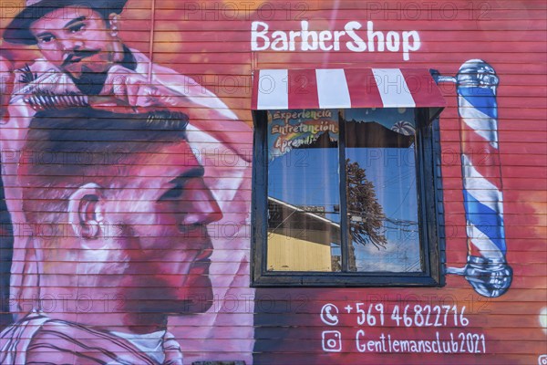 Colourful graffito, street art on the facade of a hairdresser and barber shop, city of Punta Arenas, Patagonia, Chile, South America