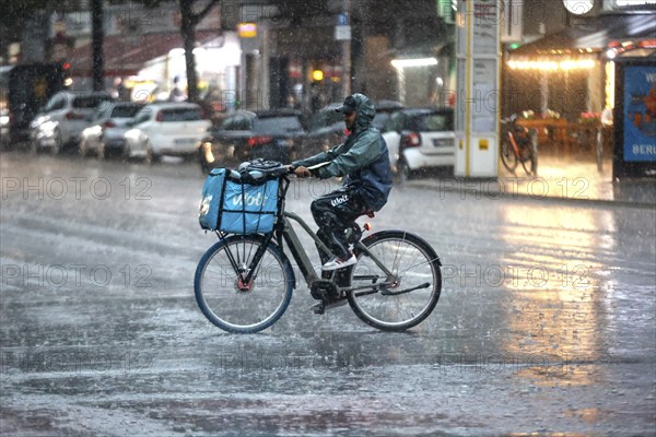 A Volt delivery driver drives along Potsdamer Strasse in the pouring rain. After weeks of heat, the first heavy rain brought cooling, Berlin, 15/08/2022