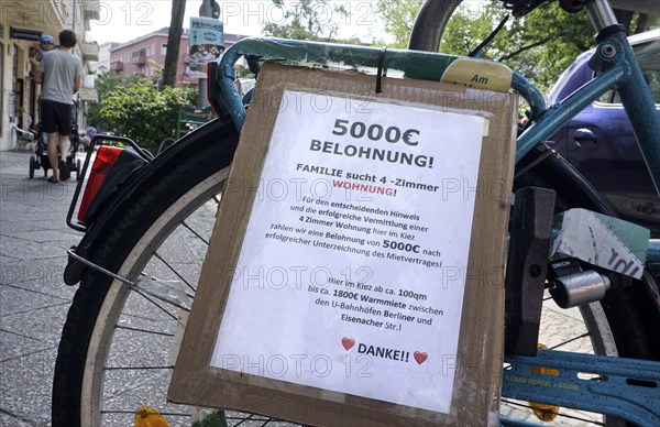 A family draws attention to their search for a flat with a poster mounted on a bicycle. The family wants to pay a €5, 000 reward for successfully finding a 4-room flat in Berlin's Schöneberg district, Berlin, 25/08/2022