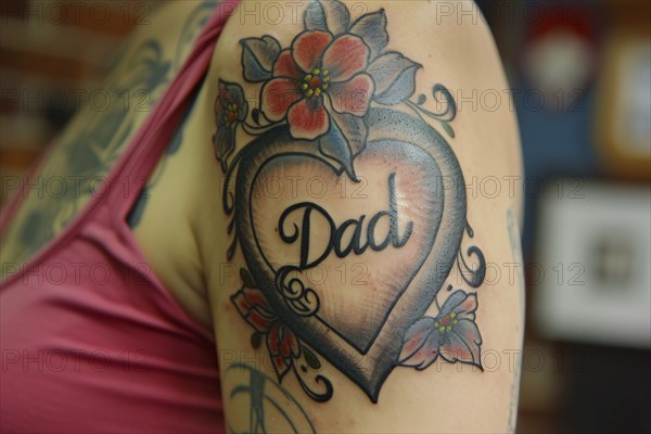 Red heart shaped tattoo with text 'Dad' on wpman's upper arm. KI generiert, generiert, AI generated