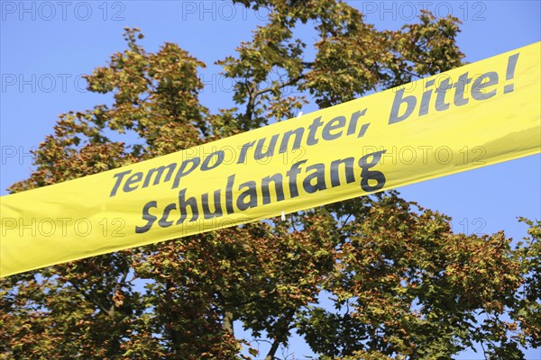 Tension tape over the road with a sign for school starters