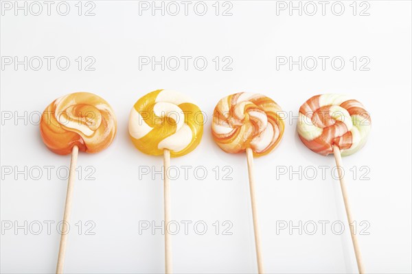 Four lollipop candies isolated on white background. close up, side view