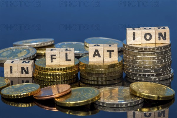 Symbolic image of inflation: euro coins and letters displaying the word INFLATION