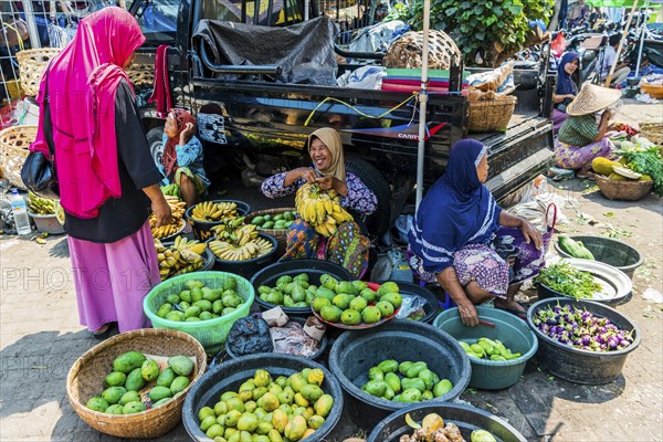 Traditional authentic food market, vendor, woman, fruit, vegetable, fresh, food, nutrition, sale, trade, bazaar, authentic, disease vector, food law, food control, stall, Asian, vegetable market, local, hygiene, virus, tradition, traditional, health, marketplace, market hall, tropical, travel, tourism, culture, poverty, presentation, cleanliness, person, Muslim, Islam, Lombok, Indonesia, Asia