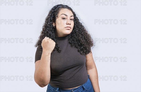 Angry woman threatening with fist isolated. Displeased girl threatening with fist. Aggressive person concept