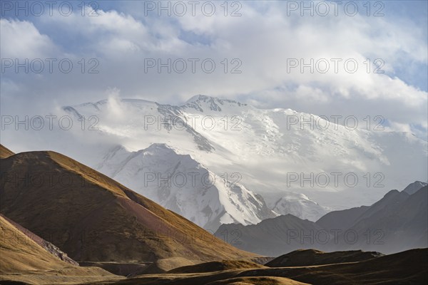 Dramatic mountain landscape, mountain valley, behind glaciated and snow-covered mountain peak Pik Lenin, Trans Alay Mountains, Pamir Mountains, Osh Province, Kyrgyzstan, Asia