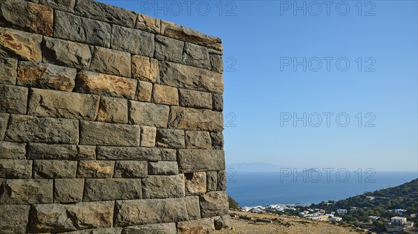 A massive stone structure overlooking the sea and the surrounding landscape under a clear sky, Palaiokastro, Ancient Fortress, 3rd and 4th century BC, above Mandraki, Nisyros, Dodecanese, Greek Islands, Greece, Europe