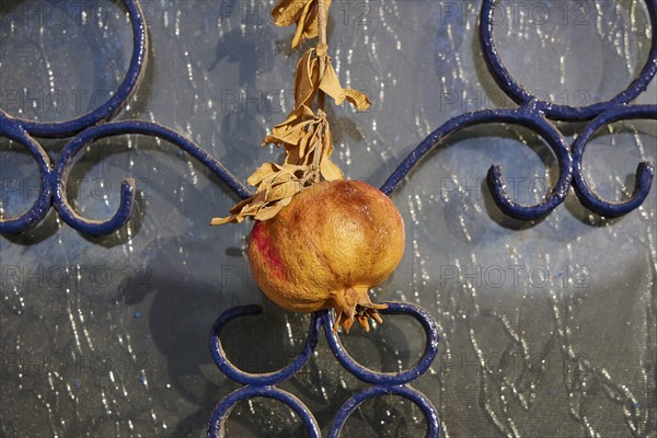 Pomegranate on ornate blue metal background, decorative detail, front door, detail, Pigadia, town and harbour, Pigadia Bay, main town, Karpathos, Dodecanese, Greek Islands, Greece, Europe