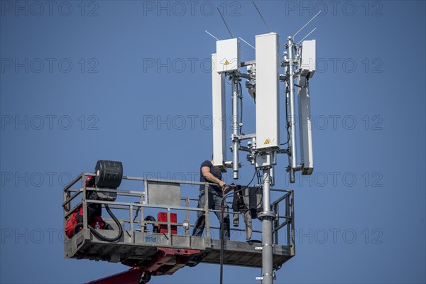 Assembly, installation of a 5G mobile radio transmitter, mast on a residential building, fast mobile internet, Düsseldorf, North Rhine-Westphalia, Germany, Europe