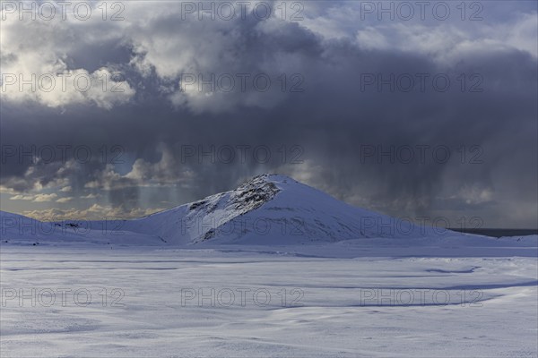 Cloudy mood and snowstorm over an old volcano, snow, winter, Neshraun, Snaefellsnes, Vesturland, Iceland, Europe