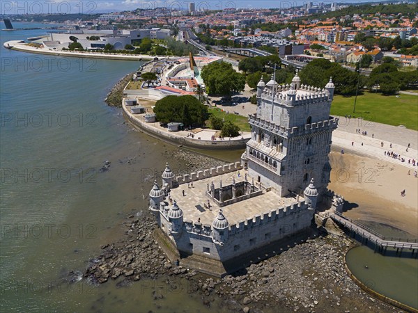 Historic tower on the coast with city in the background and blue water in the foreground, aerial view, Torre de Belém, World Heritage Site, Belem, Bethlehem, Lisbon, Lisboa, River Tagus, Portugal, Europe