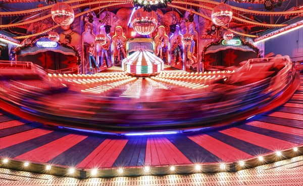 Visitors ride in a Musik Express ride, Berlin, 09.12.2022