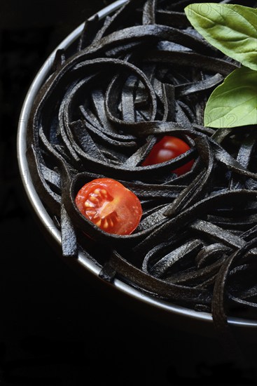 Black pasta coloured with squid ink on a plate, Taglioni al Nero di Seppia, Italy, Europe