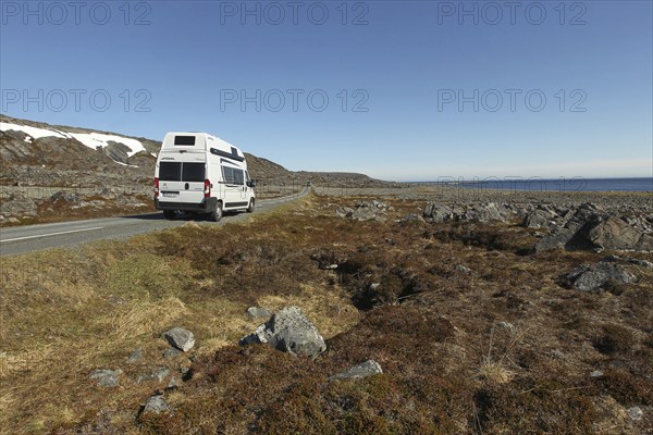 Campervan/caravan on a lonely coastal road through the tundra near Hamningberg on the Barents Sea, Lapland, Northern Norway, Norway, Scandinavia, Europe