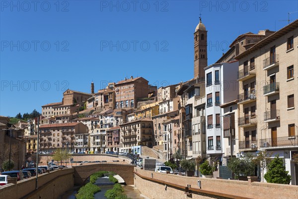 Historic town with many buildings and a prominent tower in the background next to a river under a blue sky, church, Iglesia de Santa María Magdalena, Rio Queiles, Tarazona, Zaragoza, Aragon, Spain, Europe