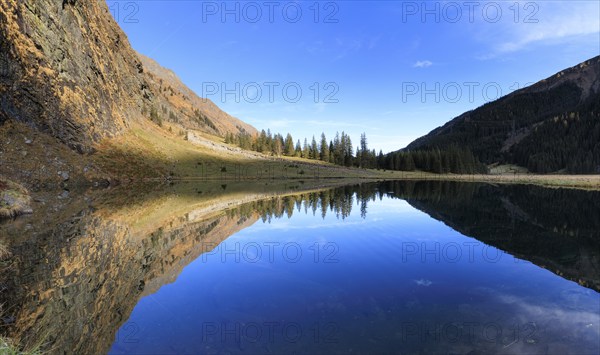 An expansive panorama shows a lake with clear mountain reflections, Felbertal, Mittersill, Salzburg, Austria, Europe