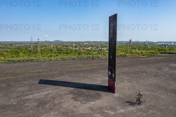 Sculpture Bramme for the Ruhr area by Richard Serra, on the Brammentrail, mountain bike trail on the Schurenbach spoil tip, in Essen North Rhine-Westphalia, Germany, Europe