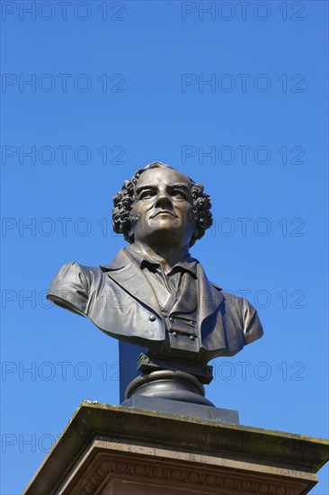 Monument in honour of Conradin Kreutzer, musician, conductor and composer, bust by Hans Baur, sculptor, sculpture, portrait, portrait, head, face, detail, pedestal, writing, letters, art in public space, statue, blue sky, cloudless, Meßkirch, district of Sigmaringen, Baden-Württemberg. Germany