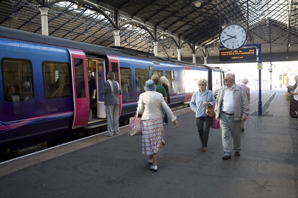 Train and passengers on platform of Scarborough railway station, Yorkshire, England, United Kingdom, Europe