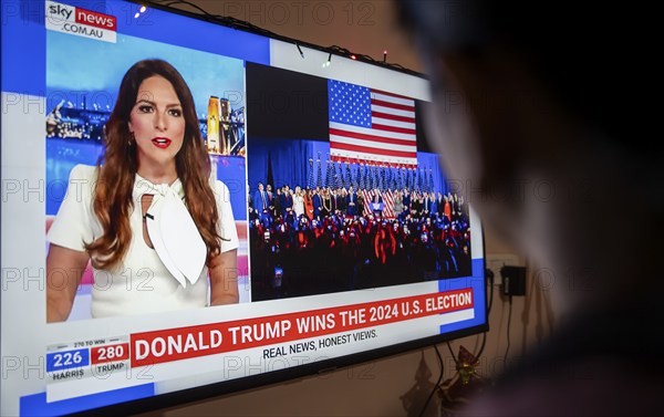 In this photo illustration, a person watch results of U.S. elections on a television in Guwahati, India on 6 November 2024. Donald Trump has won the 2024 US presidential election and a second term in the White House, four years after losing the 2020