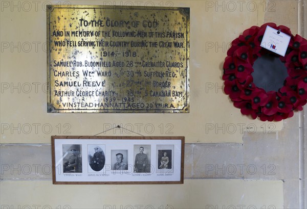 Village war memorial remembrance with names photographs poppy wreath, Boyton church, Suffolk, England, UK