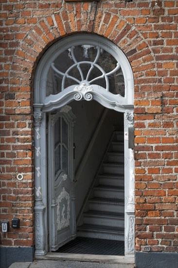 Old door decorated with wood carvings, Nikolaj Square, Copenhagen, Denmark, Europe