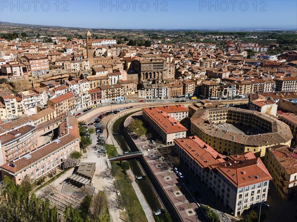 Aerial view of a historic city with tiled roofs, bridges over a river and a central square, aerial view, Plaza de Toros, bullring, Tarazona, Zaragoza, Aragon, Spain, Europe