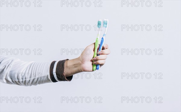 Toothbrush change concept. Hand holding two toothbrushes isolated. Oral health concept