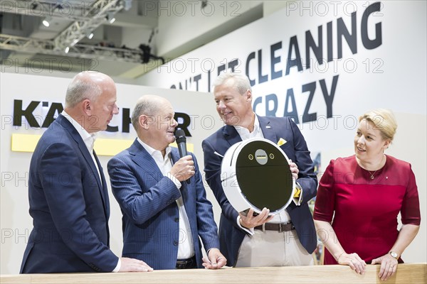 Kai Wegner (Governing Mayor of Berlin, CDU), Olaf Scholz (Chancellor of the Federal Republic of Germany, SPD) and Franziska Giffey (Senator for Economics, Energy and Public Enterprises and Mayor of Berlin, SPD) are shown robotic vacuum cleaners from Kärcher during a press tour of the IFA (Internationale Funkausstellung) exhibition at the exhibition grounds, Berlin, 06/09/2024