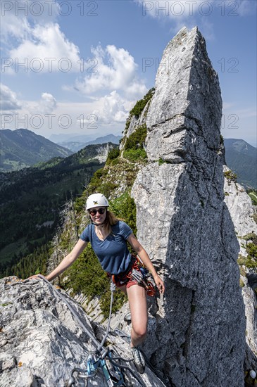 Climber on a climbing tour, climber on a mountain ridge, pointed rock peak, alpine climbing, crossing the Kampenwand, Chiemgau, Bavaria, Germany, Europe