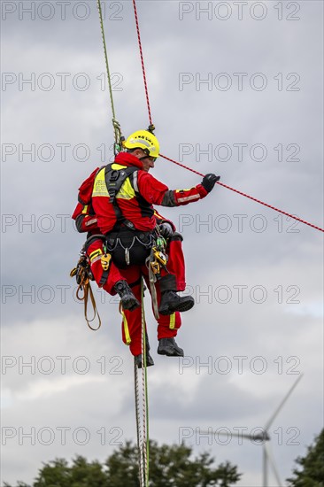 Height rescuers from the Gelsenkirchen fire brigade practise abseiling from a wind turbine from a height of 110 metres after rescuing an accident victim from the nacelle, Gladbeck, North Rhine-Westphalia, Germany, Europe