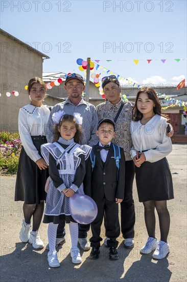 Family and schoolchild on the first day of school, Issyk-Kul region, Kyrgyzstan, Asia