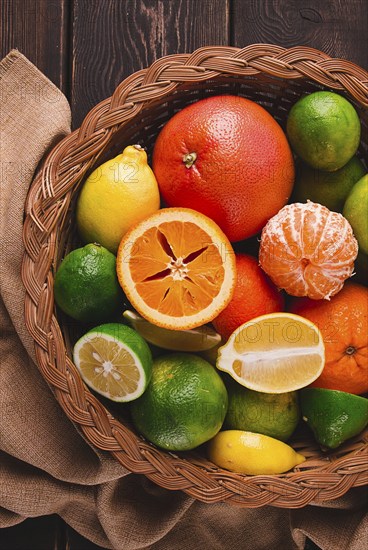 Assortment, citrus fruits, in a basket, close-up, top view, no people