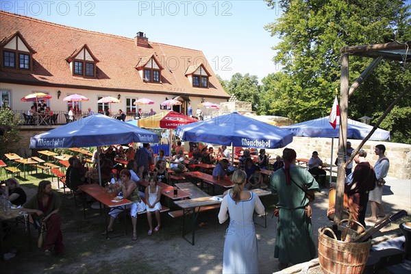 Beer garden at Königsberg Castle, a medieval imperial castle overlooking the town of Koenigsberg in Bavaria, Hassberge district, Lower Franconia, Bavaria, Germany, Europe