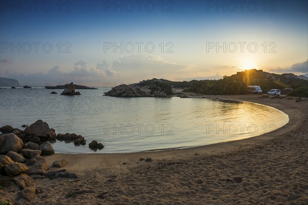 Lonely beach with granite rocks and campers, wild campsite, sunrise, Spiaggia Poltu Manzu, Capo Ceraso, near Olbia, Sardinia, Italy, Europe