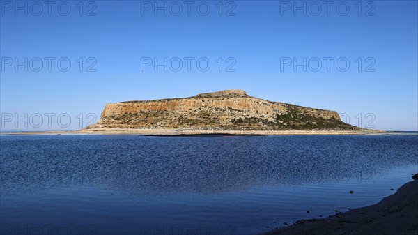 Rocky island in front of calm blue sea under clear sky, peaceful scene, Gramvoussa, Gramvoussa peninsula, pirate bay, Balos, lagoon, north-west Crete, Crete, Greek Islands, Greece, Europe