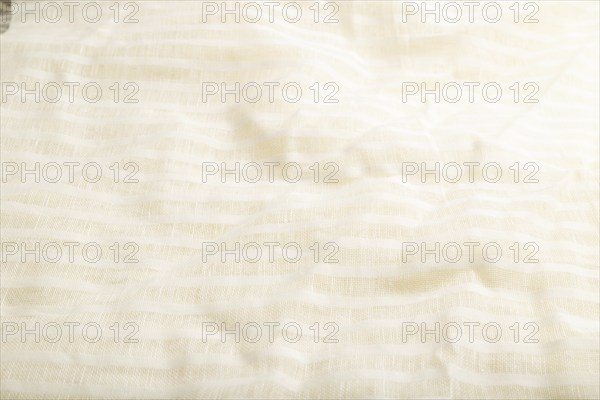 Fragment of smooth white linen tissue. Side view, natural textile background and texture