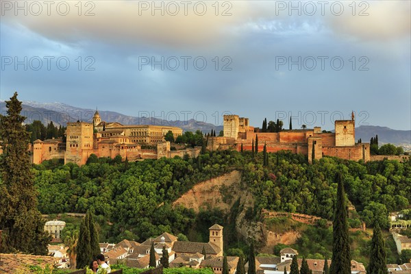 Alhambra on the Sabikah hill at sunset, Moorish city castle, Nasrid palaces, Sierra Nevada with snow remains in the background, Mirador de San Nicolas, Granada, Andalusia, Spain, Europe