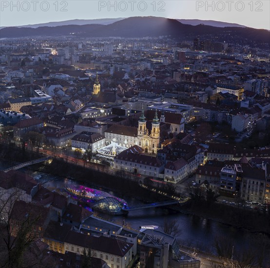 Evening atmosphere, view from the Schlossberg to the illuminated Murinsel and the Mariahilferkirche, old town centre of Graz, Styria, Austria, Europe