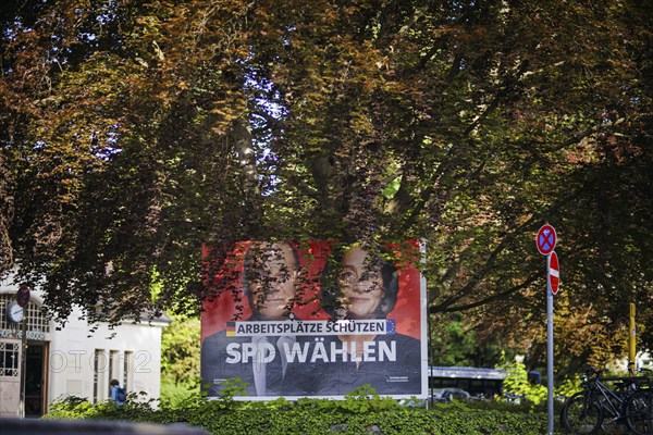 An SPD election poster for the European elections with Federal Chancellor Olaf Scholz and lead candidate Katarina Barley stands under a tree in Berlin Hermsdorf. Berlin, 08.05.2024